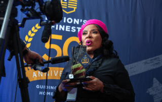 Ginger Miller holds NF50 Award for Veterans Support at Award Celebration