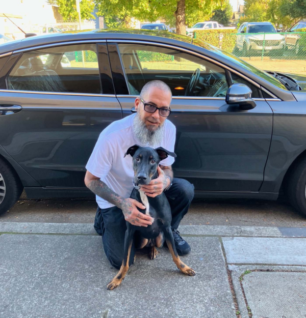 Robert poses for a picture with his dog